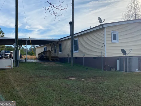 a view of backyard of house with green space