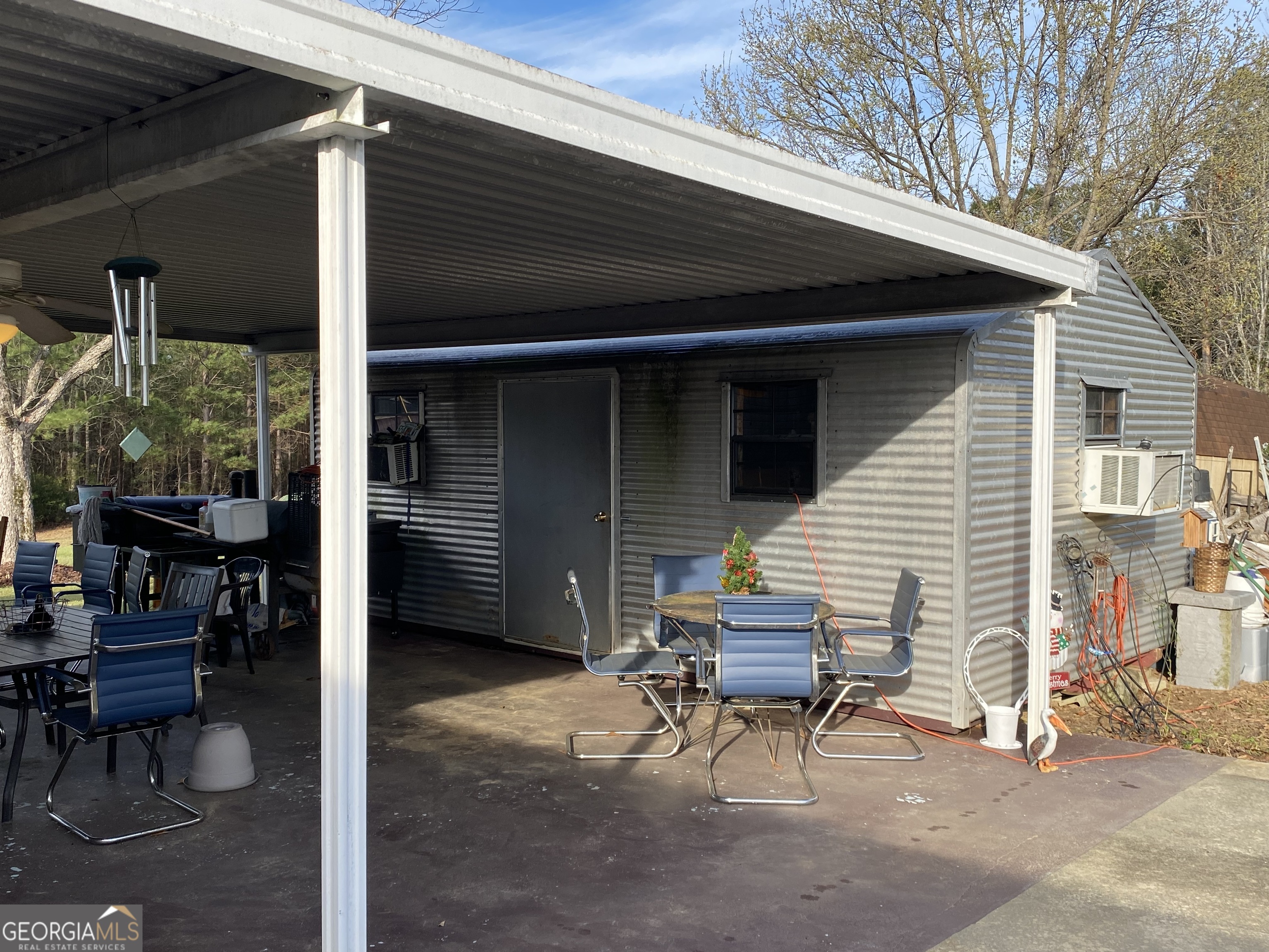 580 Centralia Rachels Road Warthen, GA 31094 - Photo 8 of 40 a view of a patio with table and chairs and a barbeque