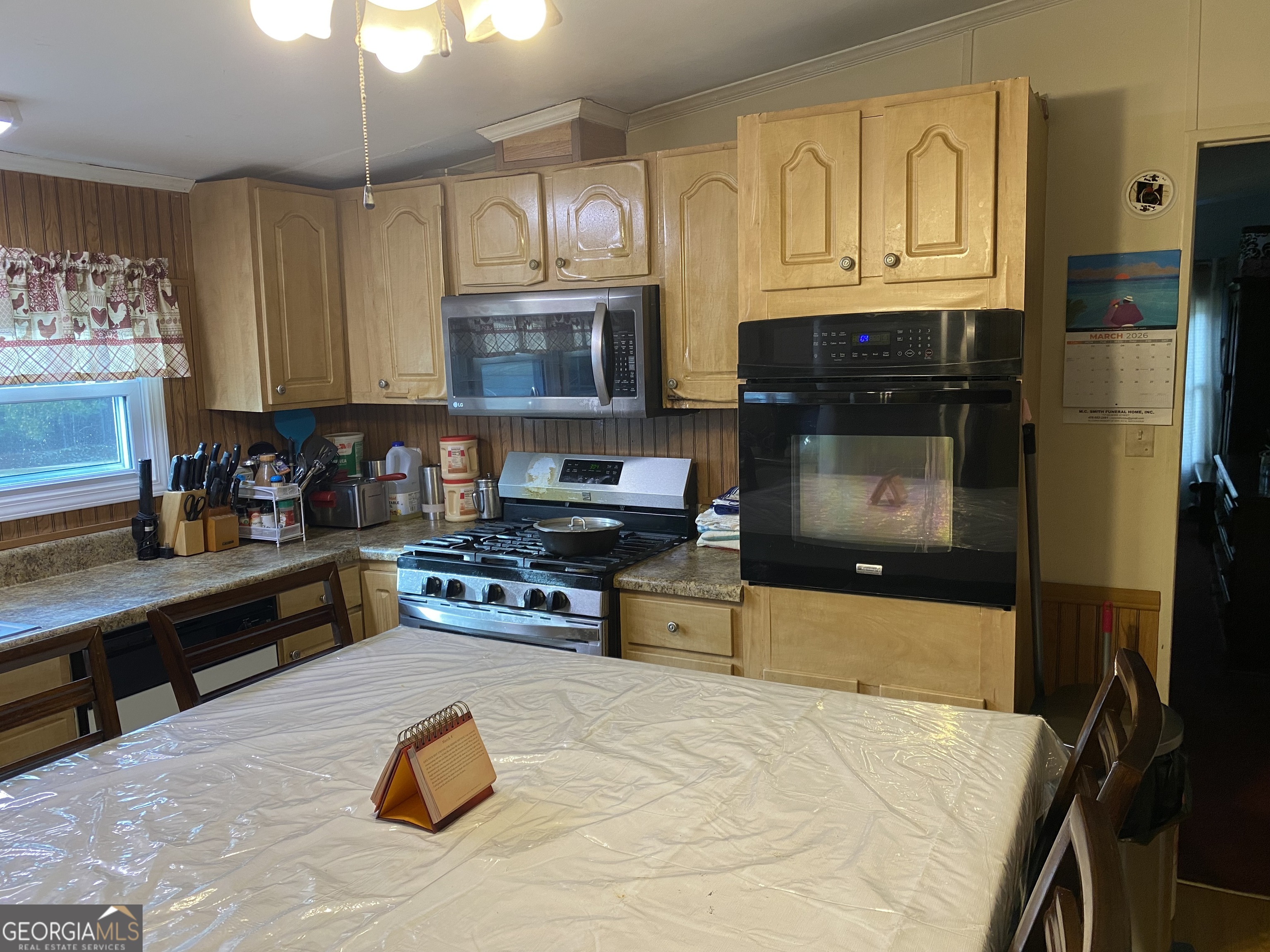 580 Centralia Rachels Road Warthen, GA 31094 - Photo 10 of 40 a kitchen with stainless steel appliances granite countertop a stove top oven a sink dishwasher and a microwave