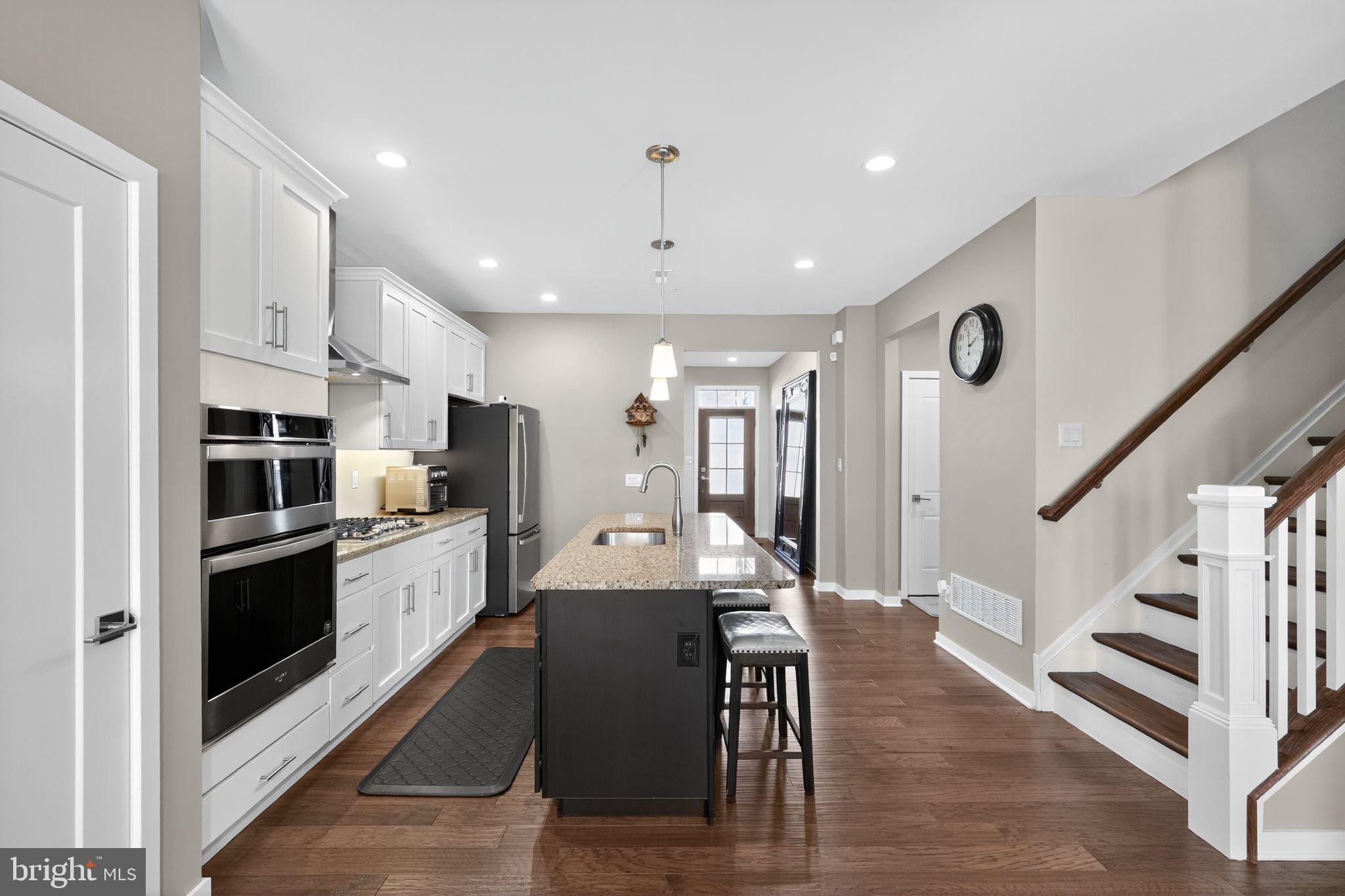 417 Wynstone Court Colmar, PA 18915 - Photo 6 of 30 a kitchen with stainless steel appliances kitchen island granite countertop a refrigerator and a stove top oven