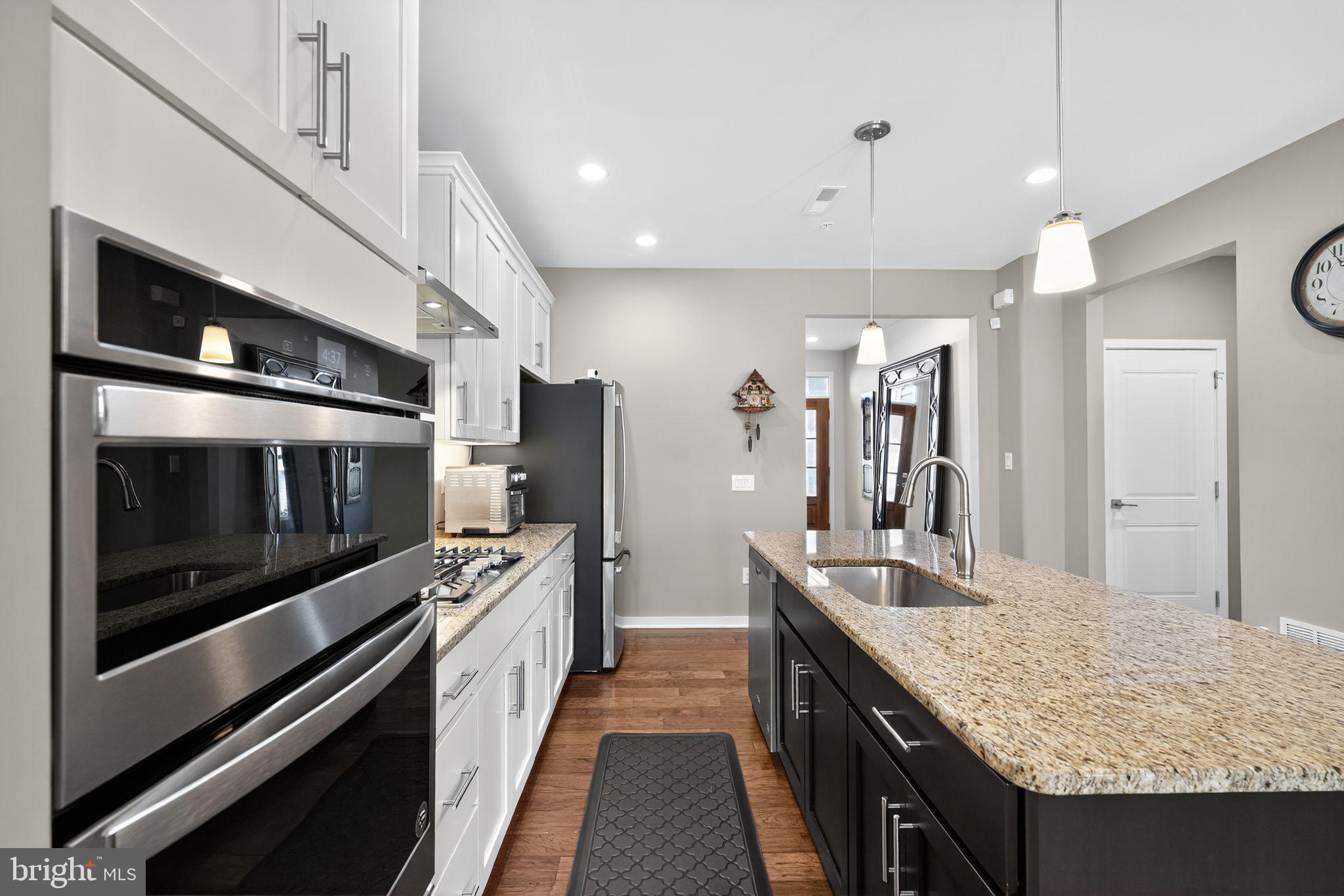 417 Wynstone Court Colmar, PA 18915 - Photo 7 of 30 a kitchen with stainless steel appliances kitchen island granite countertop a stove and a microwave