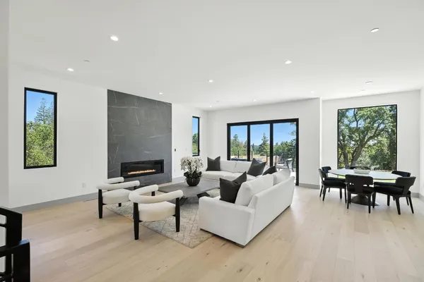 a living room with furniture and floor to ceiling windows
