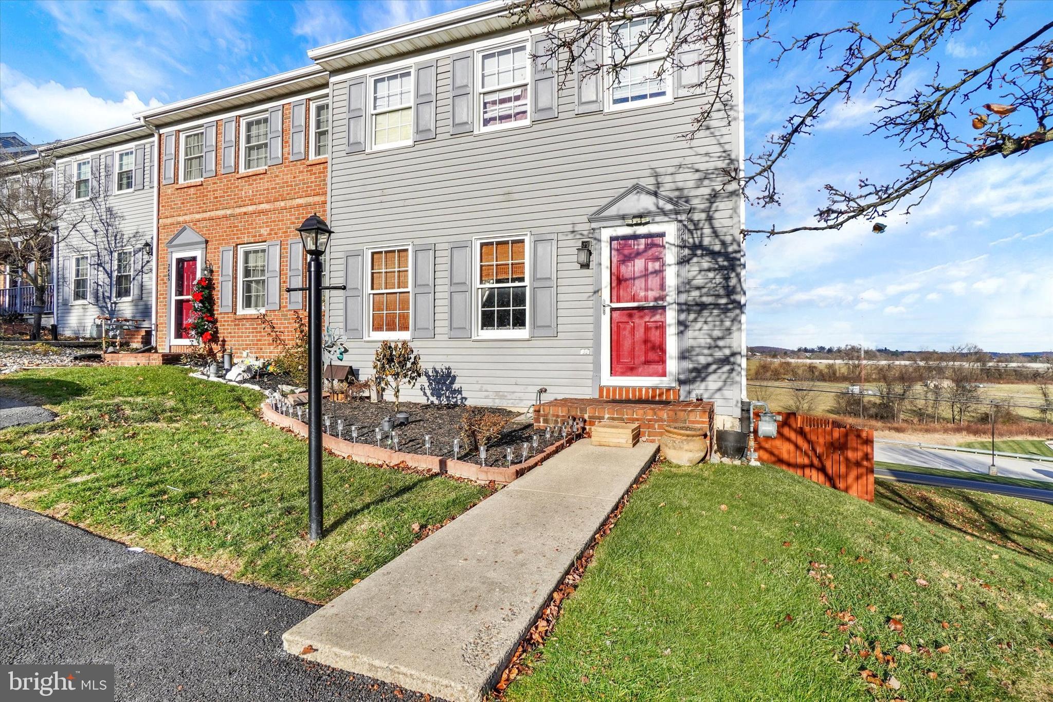 2455 Woodmont Drive York, PA 17404 - Photo 22 of 28 a front view of a house with a yard table and chairs