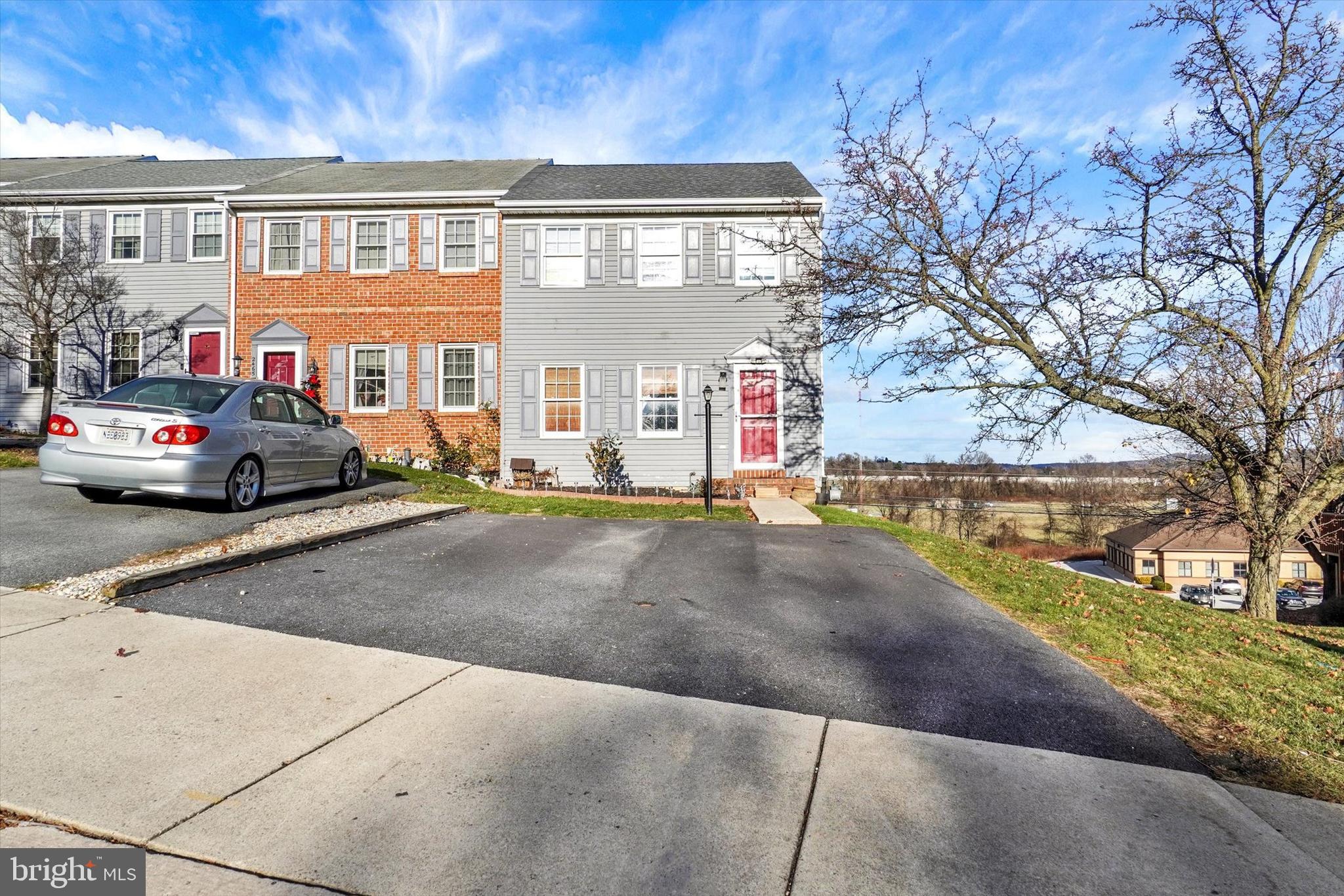 2455 Woodmont Drive York, PA 17404 - Photo 23 of 28 a front view of a house with a yard and garage