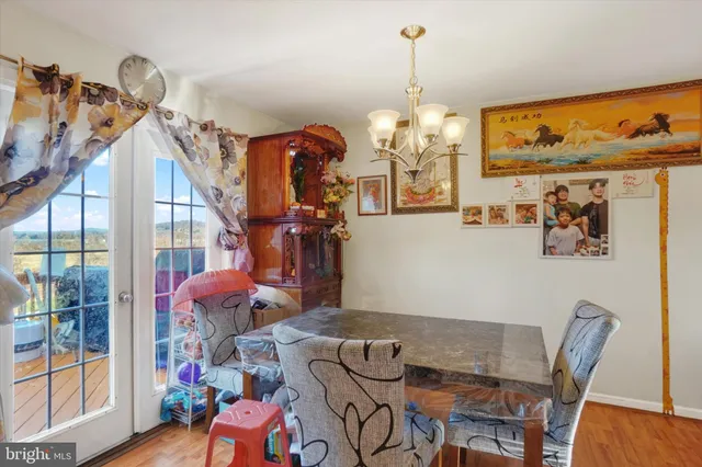 a view of a dining room with furniture wooden floor and a chandelier