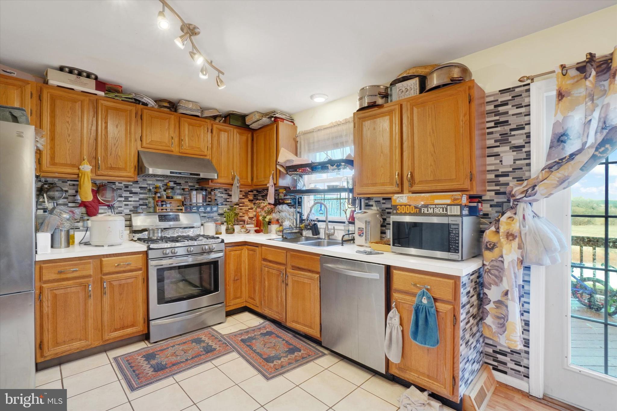 2455 Woodmont Drive York, PA 17404 - Photo 6 of 28 a kitchen with stainless steel appliances granite countertop a stove and a sink