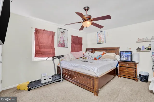 a spacious bedroom with a bed and a chandelier