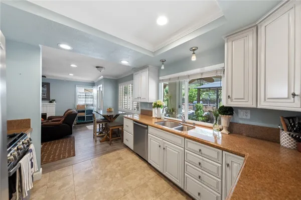 a kitchen with stainless steel appliances granite countertop a refrigerator and a stove top oven
