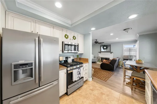 a large kitchen with white cabinets and white appliances