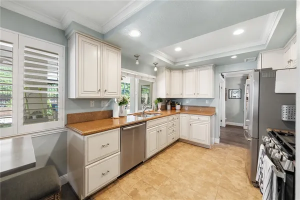a large kitchen with stainless steel appliances granite countertop a lot of counter space and wooden floor