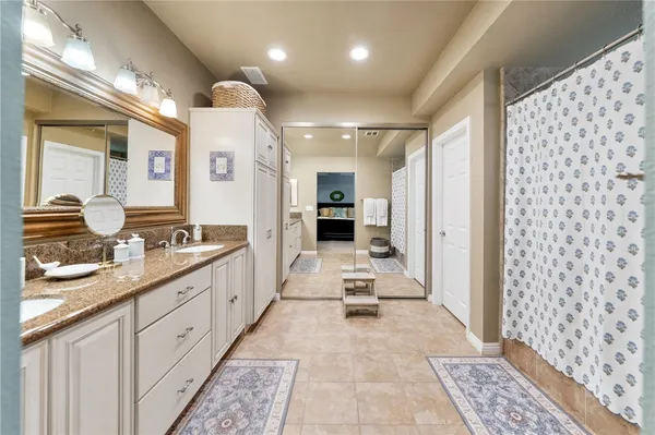 a large bathroom with a double vanity sink and a mirror
