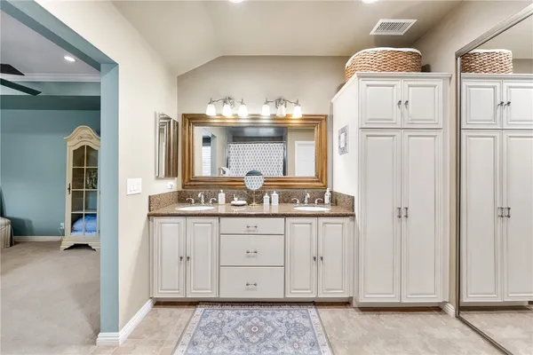 a bedroom with a bed furniture a desk and a large window