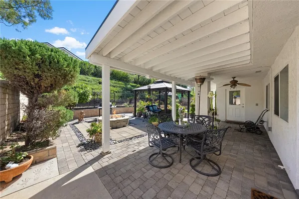 a view of a patio with chairs and plants