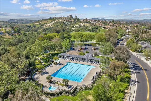 an aerial view of house with swimming pool and garden