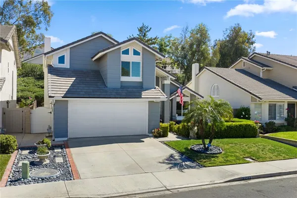 a front view of a house with a yard garage and outdoor seating