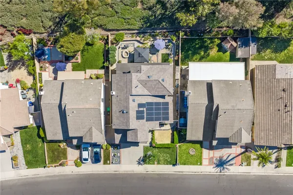 an aerial view of multiple house with outdoor space and parking