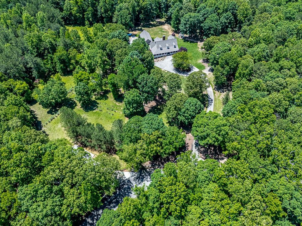 397 Thomas Road Dallas, GA 30132 - Photo 3 of 108 an aerial view of residential house with outdoor space and trees all around