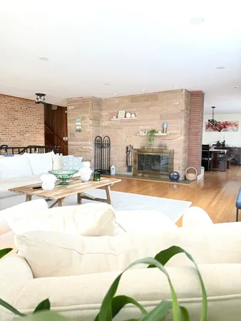 a living room with furniture and a floor to ceiling window