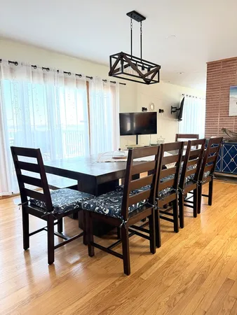 a view of a dining room with furniture and wooden floor