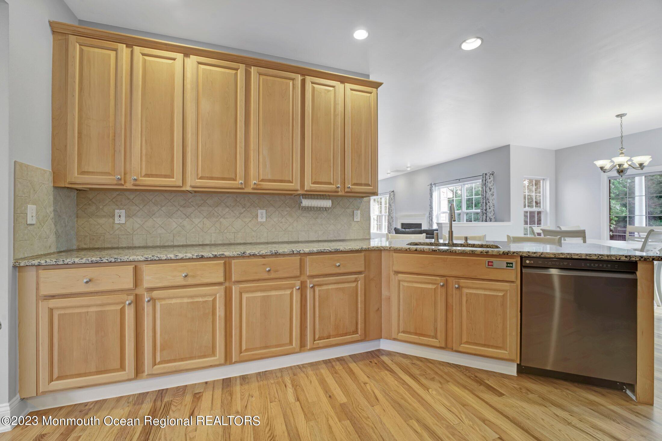 601 Reed Road Jackson, NJ 08527 - Photo 11 of 43 a kitchen with granite countertop cabinets sink and wooden floor