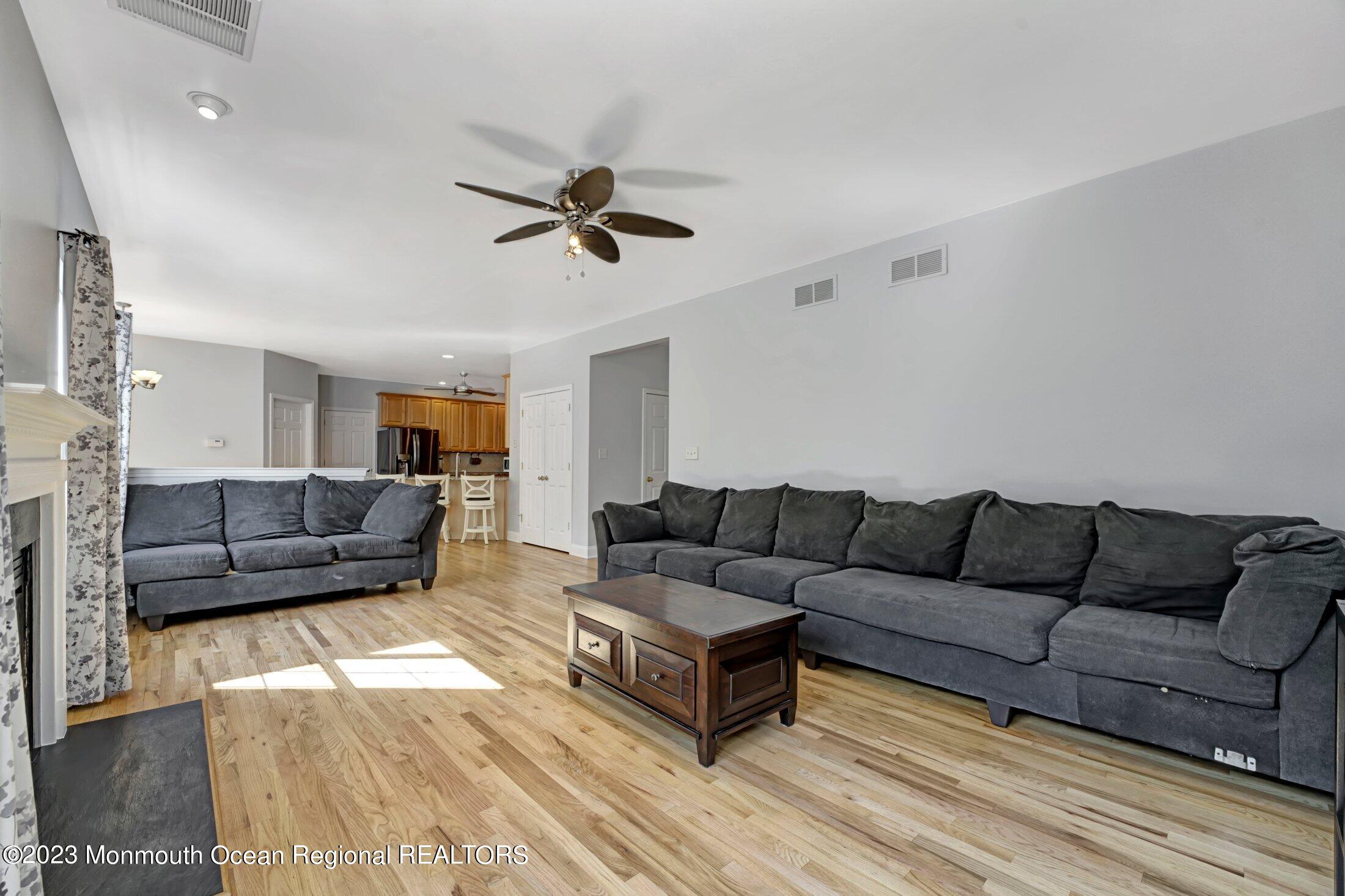 601 Reed Road Jackson, NJ 08527 - Photo 16 of 43 a living room with furniture and a wooden floor