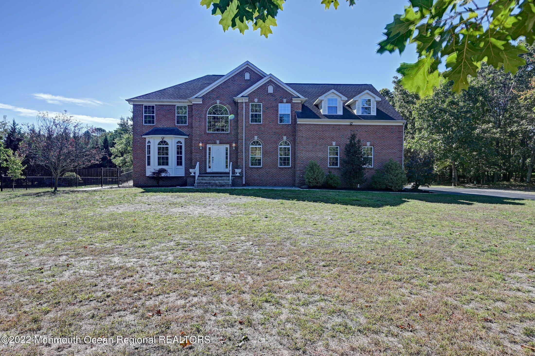 601 Reed Road Jackson, NJ 08527 - Photo 2 of 43 a view of a big house with a yard and a large tree