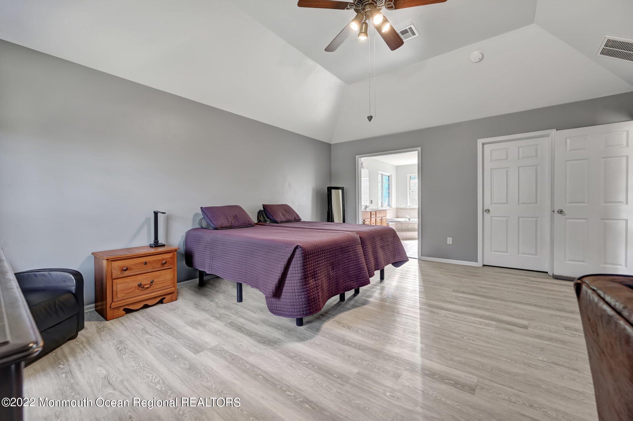 601 Reed Road Jackson, NJ 08527 - Photo 22 of 43 a spacious bedroom with a bed and ceiling fan