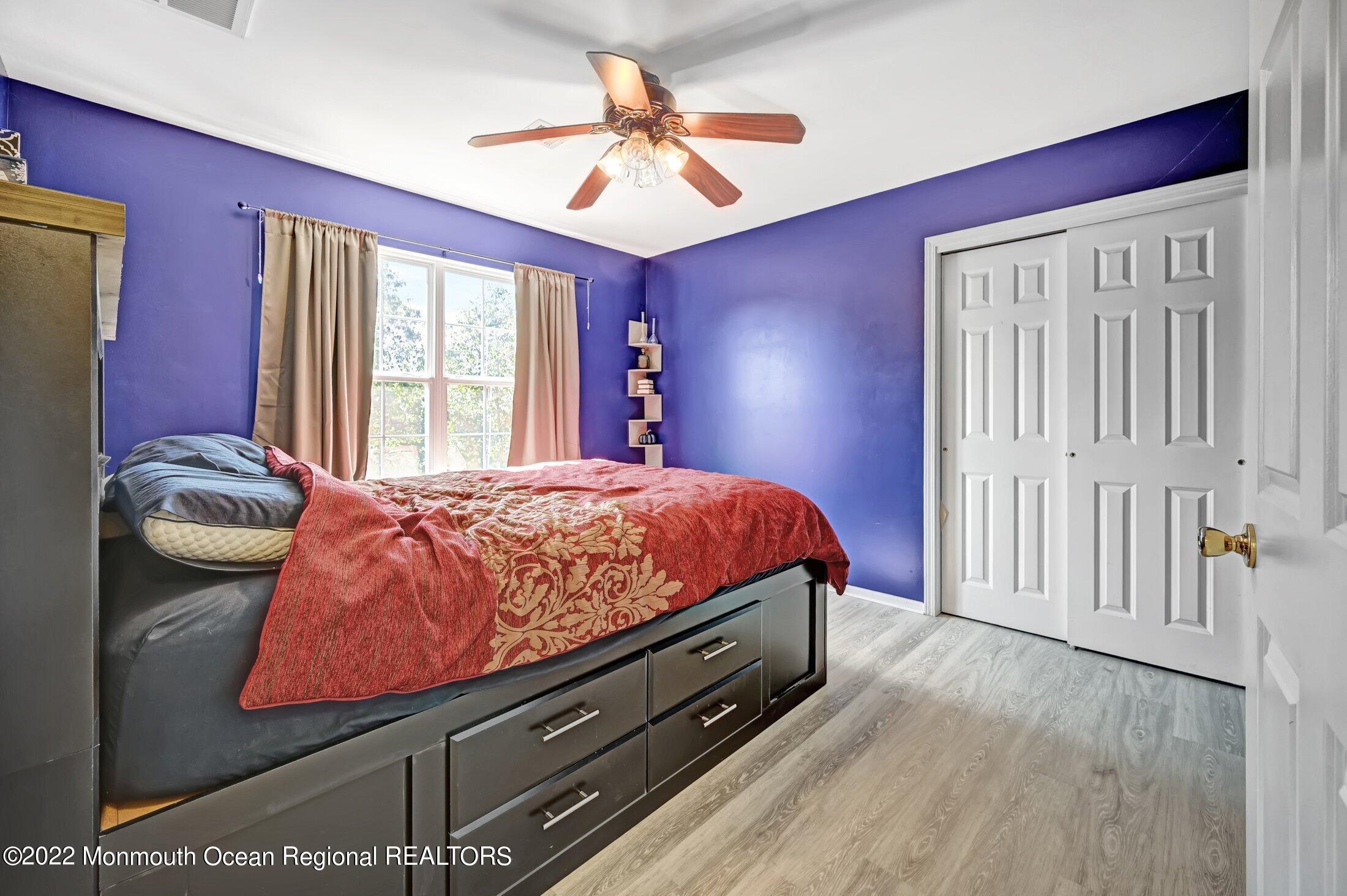 601 Reed Road Jackson, NJ 08527 - Photo 26 of 43 a bedroom with a bed and dresser with wooden floor