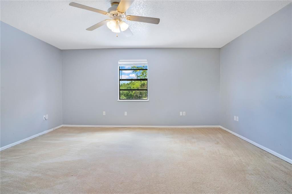 5785 Gilliam Road Orlando, FL 32818 - Photo 75 of 100 an empty room with a window and a fan