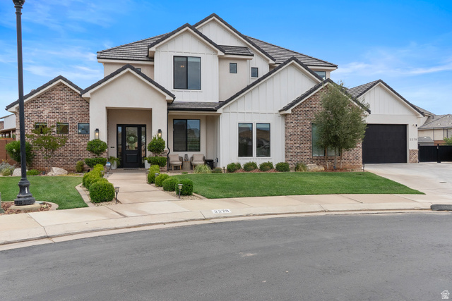 2278 Tawny Ridge Circle St. George, UT 84790 - Photo 1 of 61 Contemporary residence featuring a stucco and brick exterior with board and batten accents.