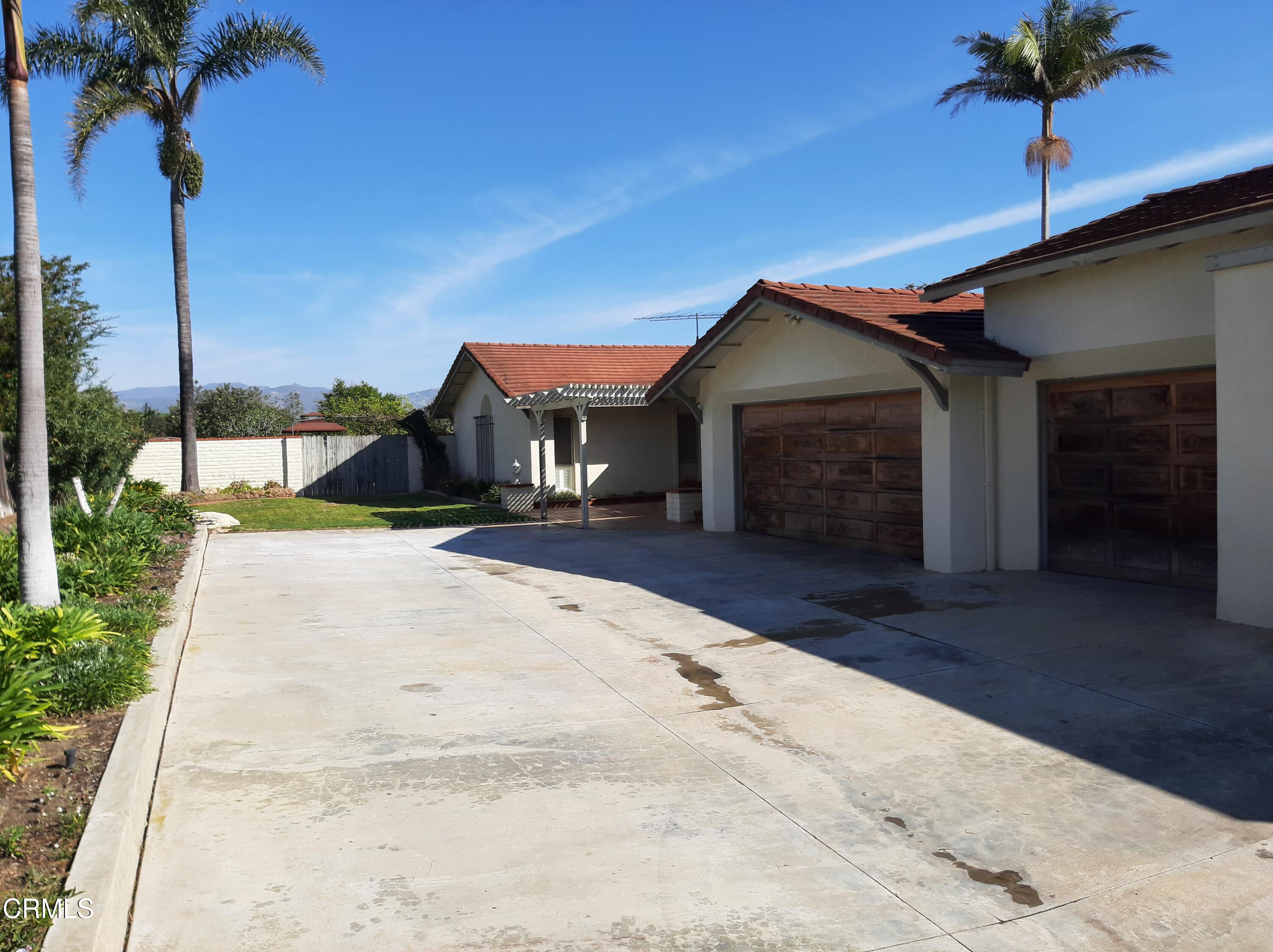3166 Old Coach Drive Camarillo, CA 93010 - Photo 3 of 55 a front view of a house with a yard and garage