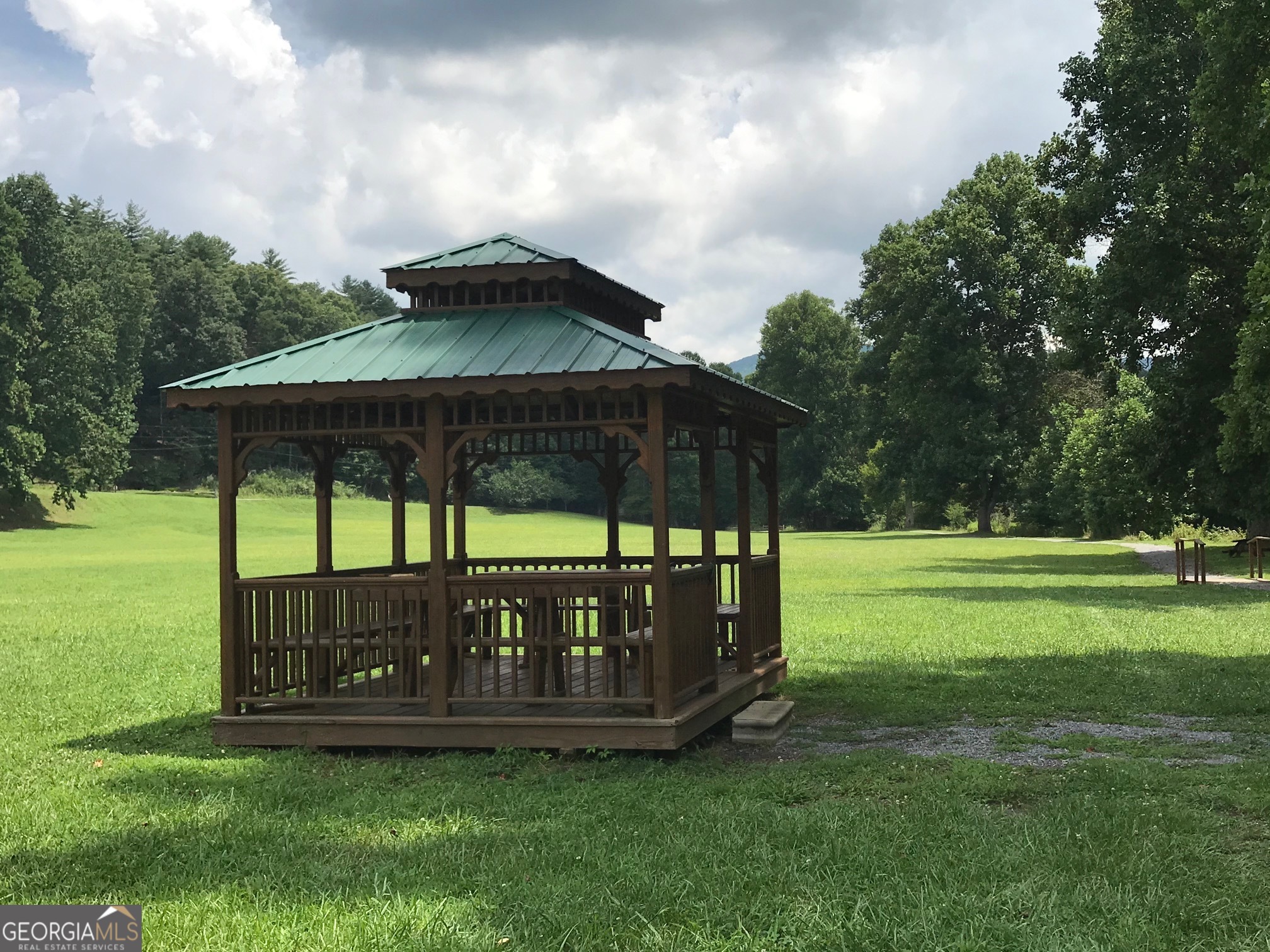 573 Cataula Court Ellijay, GA 30540 - Photo 13 of 13 a view of a chair and table and chairs under an umbrella