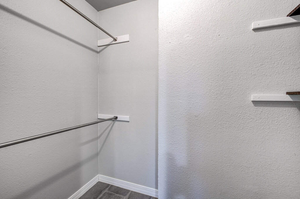 12925 Covington Trail Austin, TX 78727 - Photo 20 of 28 Walk in closet featuring dark wood-style floors