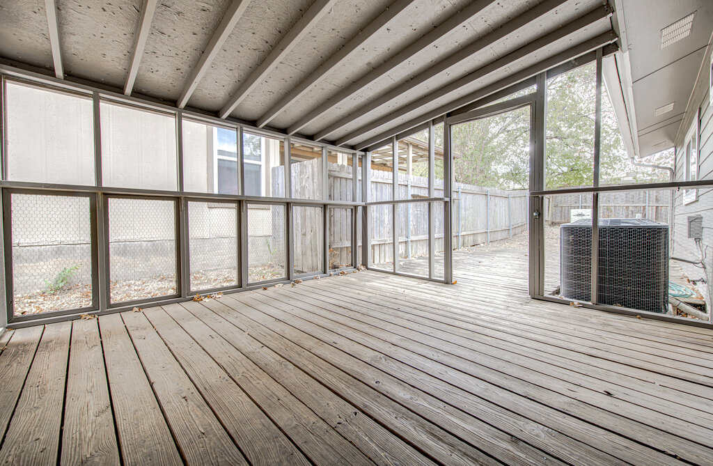 12925 Covington Trail Austin, TX 78727 - Photo 21 of 28 Unfurnished sunroom featuring vaulted ceiling and a deck