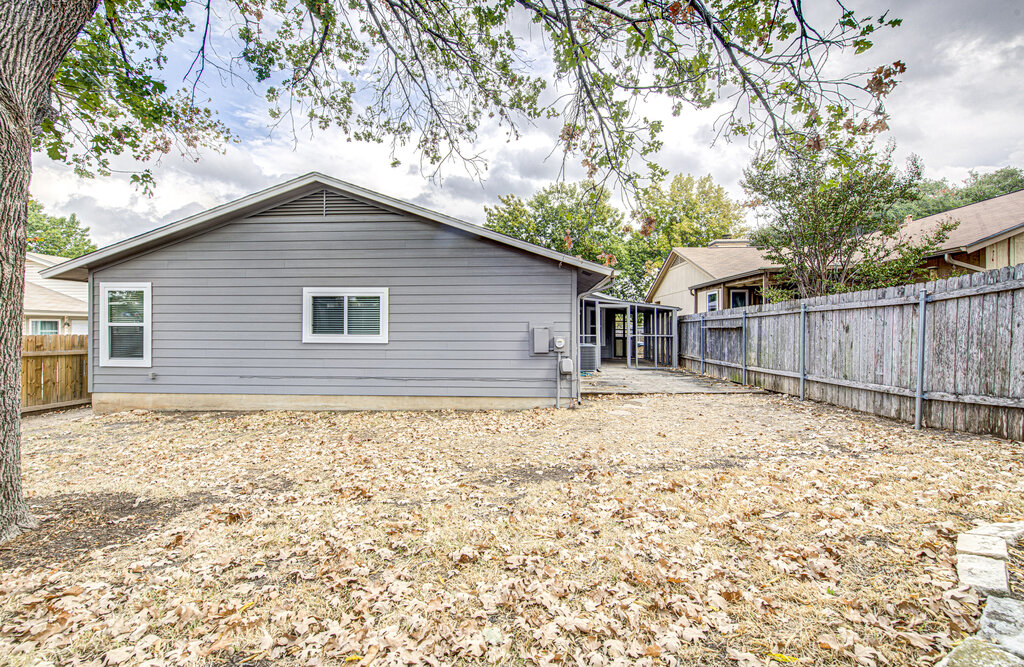 12925 Covington Trail Austin, TX 78727 - Photo 26 of 28 Back of property with a fenced backyard and a patio area