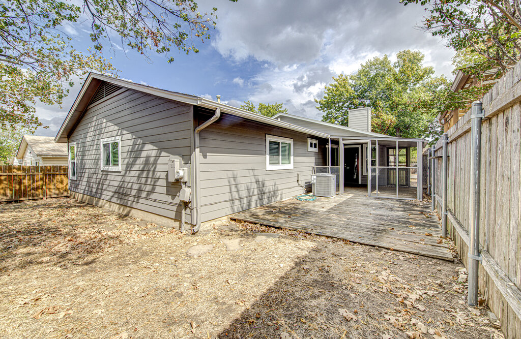 12925 Covington Trail Austin, TX 78727 - Photo 28 of 28 Rear view of house with a fenced backyard, a chimney, and a deck