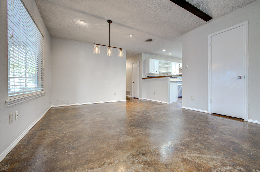 12925 Covington Trail Austin, TX 78727 - Photo 6 of 28 Unfurnished living room with a textured ceiling, finished concrete floors, and recessed lighting