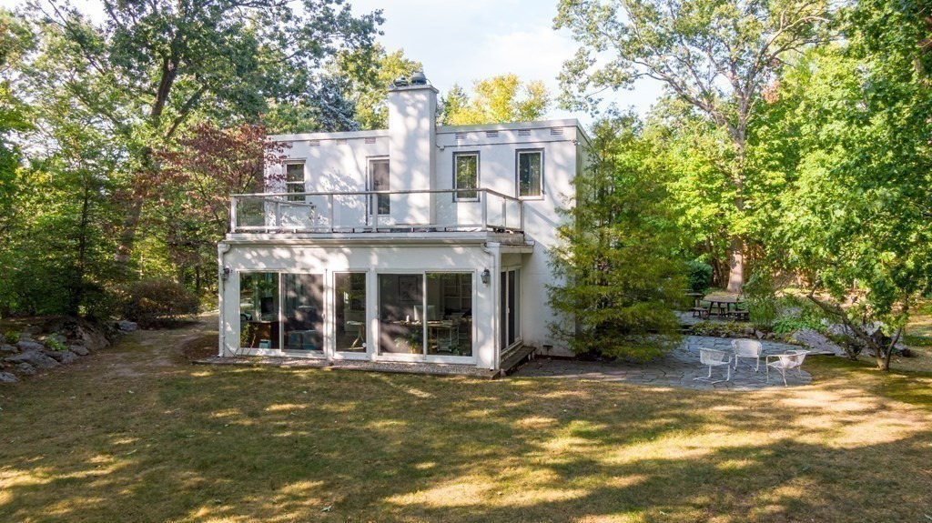 260 Lee Street Brookline, MA 02445 - Photo 20 of 22 a view of a white house with large windows and a small yard