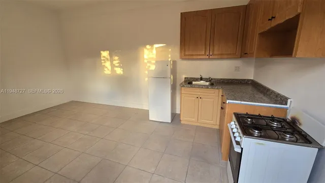 a kitchen with a stove and a refrigerator