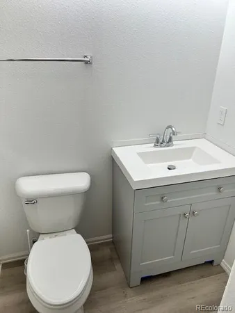 a white toilet sitting next to a white sink