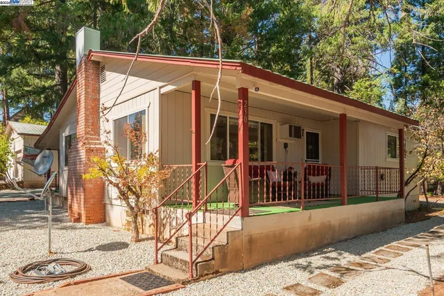 a view of a house with backyard and sitting area