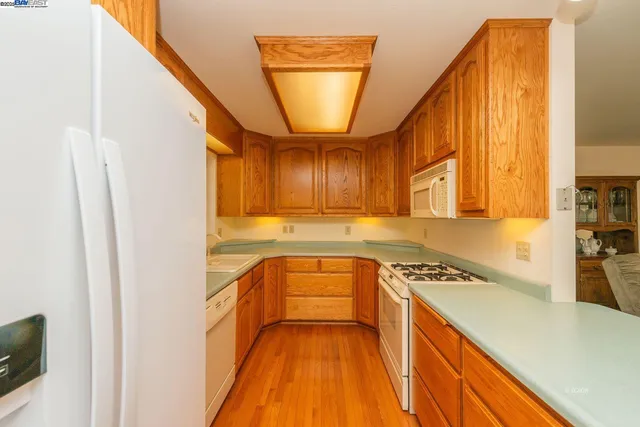 a kitchen with a stove a sink and a refrigerator