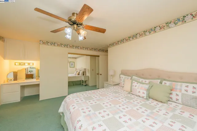a bedroom with a large bed and a chandelier