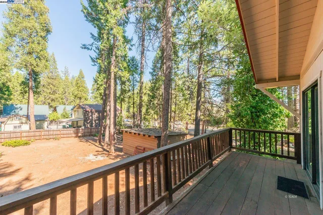 a view of a balcony with trees