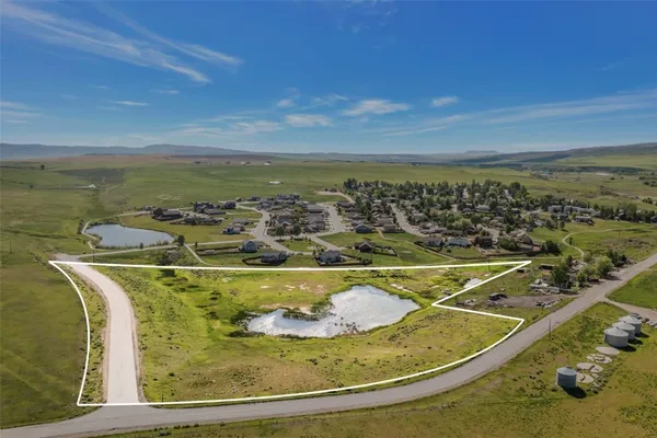 a view of a swimming pool with a table and chairs