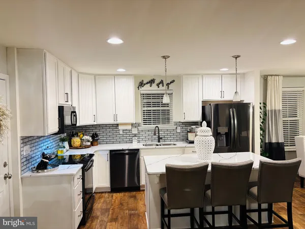 a kitchen with a sink stove and refrigerator