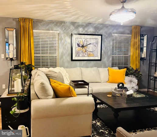 a living room with furniture flowerpot and window