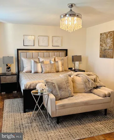 a living room with a couch and chandelier