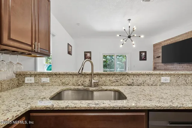 a living room with furniture a flat screen tv and a window