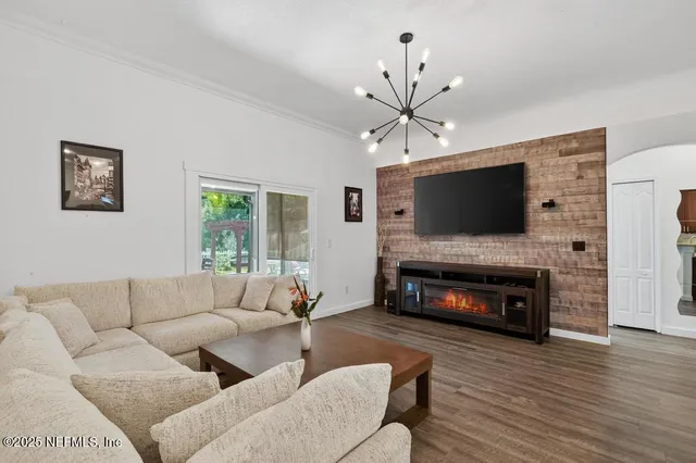 a living room with kitchen island furniture and a wooden floor
